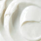Close-up of smooth white cream with a glossy swirl texture