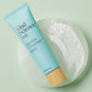 Kind Science Gentle Cleanser product on a pale green background with a creamy swirl