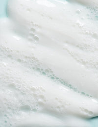 Close-up of white, foamy cleanser with small bubbles