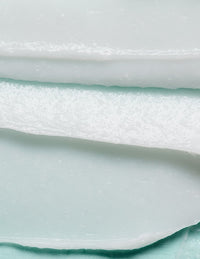 Close-up of layered white and pale green textured surface