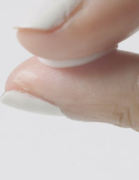 Close-up demo of cream used for face and neck skincare