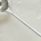 Close-up of a smooth, creamy white substance being stirred
