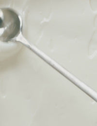 Close-up of a smooth, creamy white substance being stirred